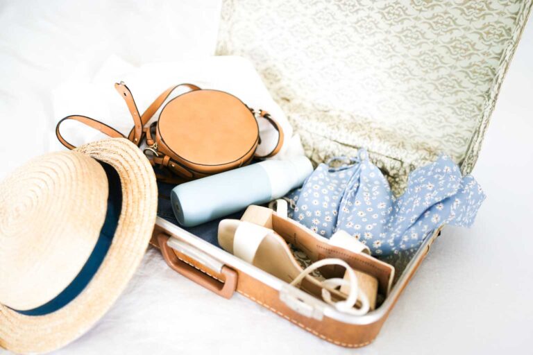 Person packing a suitcase for one of the best weekend getaways from Fort Lauderdale.