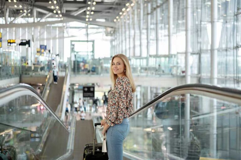 Woman inside the FLL airport terminal after using off-site parking at Fort Lauderdale Airport